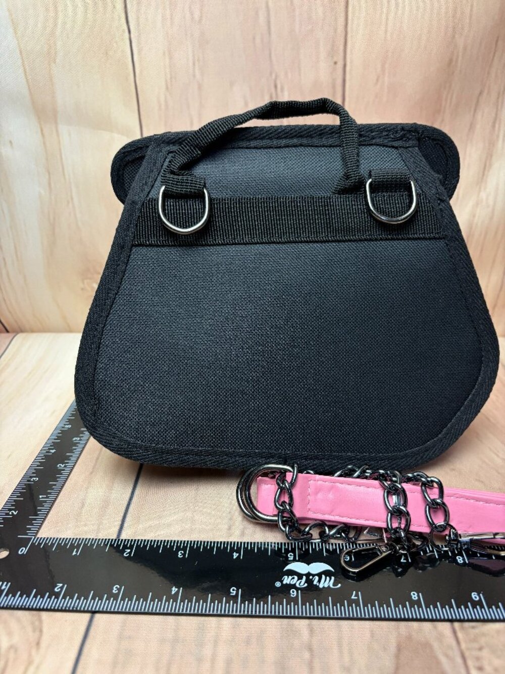 Small handbag featuring a colorful striped design in several colors.